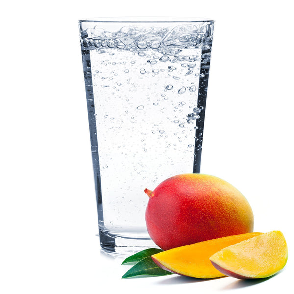 A glass of Mango Hard Seltzer with a sliced mango next to it.