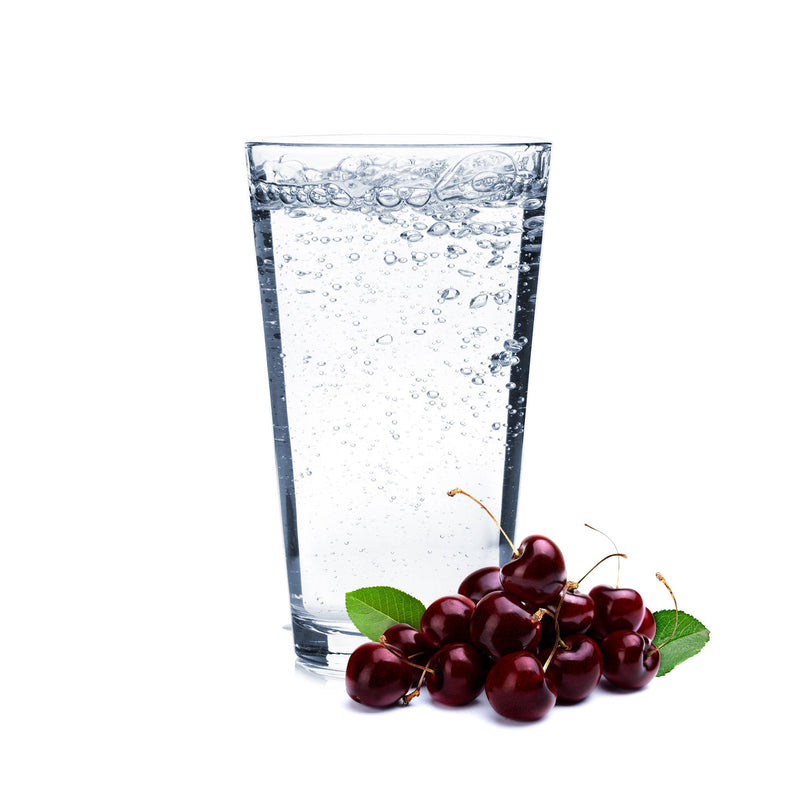 A glass of Black Cherry Hard Seltzer with cherries next to it.