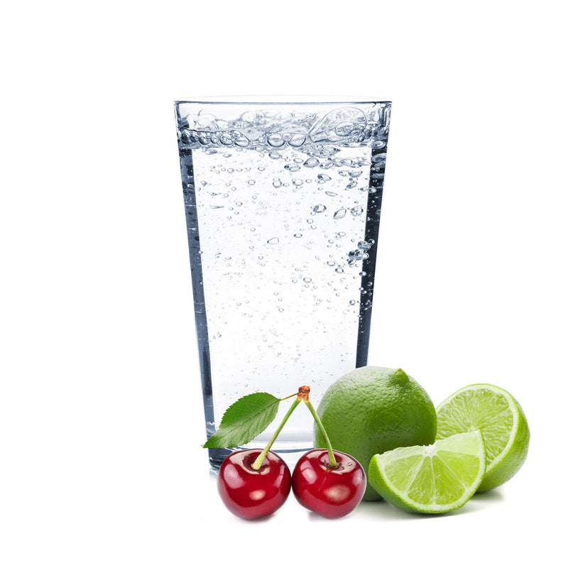 A glass of Cherry Lime Hard Seltzer with cherries and lime wedges next to it.